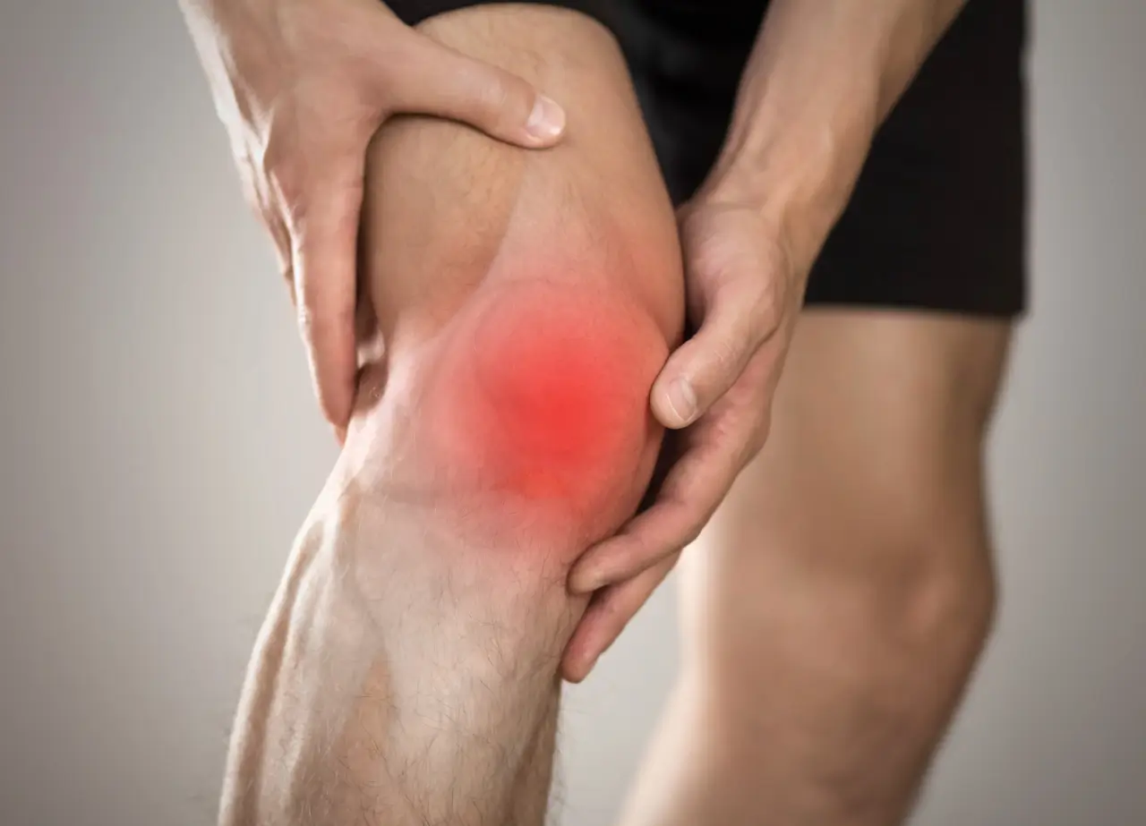 a person holding a knee.