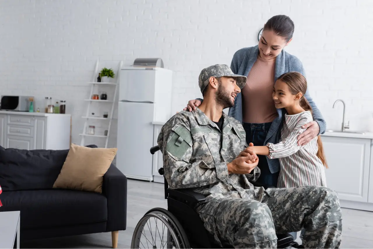 a soldier in a wheelchair with a woman and a girl.